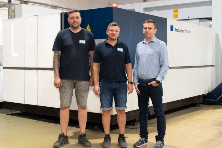 Geschäftsführer Mathias Schießl, Paul Michalski und Michal Sebo stehen vor der TRUMPF TruLaser 5030 in der Fertigungshalle der MS Metalltechnik Schießl GmbH in Rötz